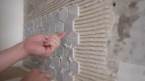 The master sets the crosses between the tiles. Video stock 195096438