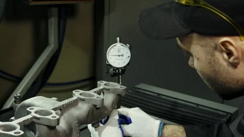 The master sets up a precision micrometer before polishing and a groove of the Stock Footage 284545675