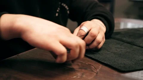 The master sews a leather bag, sewing of leather goods Stock Footage 151207833