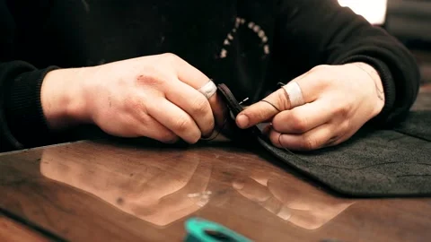 The master sews a leather bag, sewing of leather goods Stock Footage 151207836