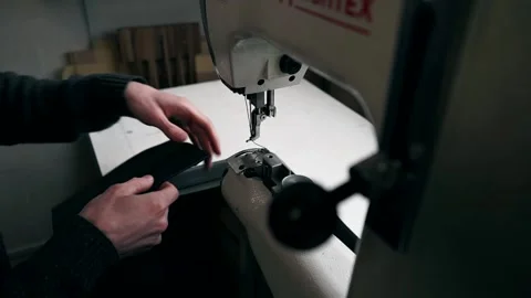 The master sews leather on a sewing machine, sewing of leather goods Stock Footage 151207754