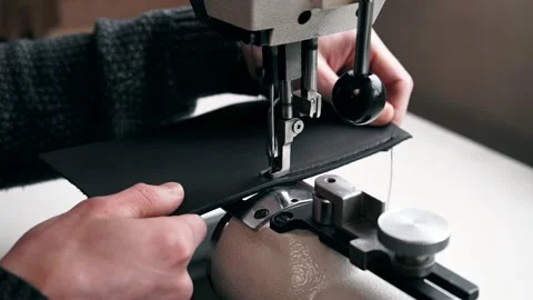 The master sews leather on a sewing machine, sewing of leather goods Stock Footage 151207760