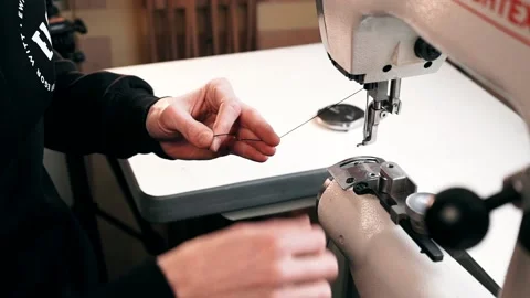 The master sews leather on a sewing machine, sewing of leather goods Stock Footage 151207780