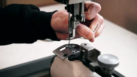 The master sews leather on a sewing machine, sewing of leather goods Stock Footage 151207782