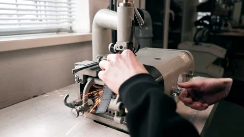The master sews leather on a sewing machine, sewing of leather goods Stock Footage 151207789