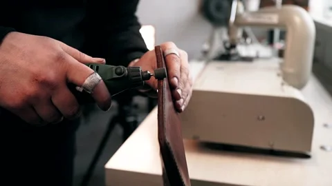 The master sews leather on a sewing machine, sewing of leather goods 動画素材 151207793