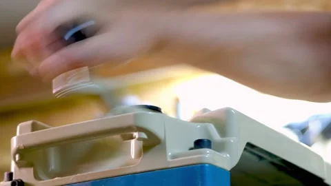 The master sharpens the board on the machine Stock Footage 177003733