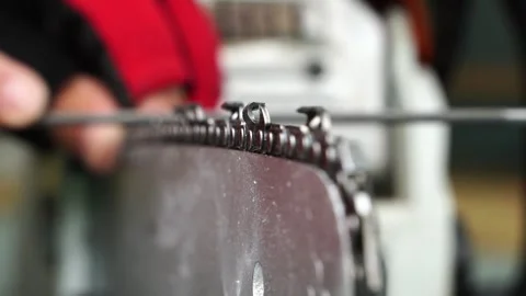 The master sharpens the cap of a chainsaw before work Stock Footage 323164391