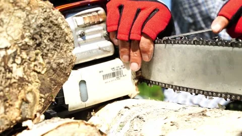The master sharpens the cap of a chainsaw before work Stock Footage 323164603