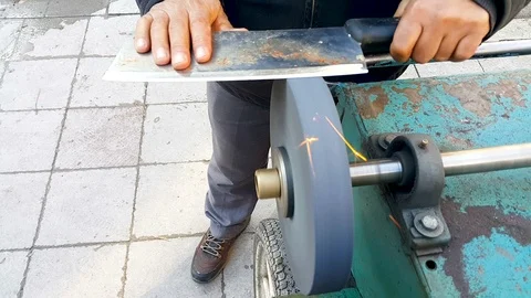 Master sharpens a knife on the machine Stock Footage 101050355