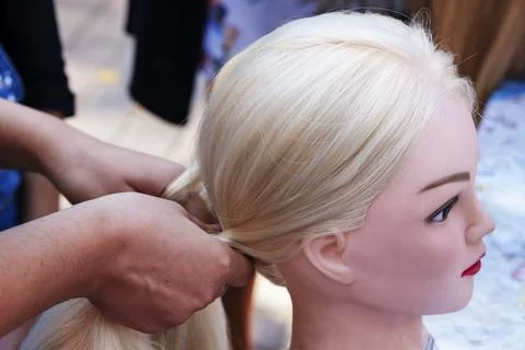 The master shows how to braid a braid. A master class for hairdressers. Tra.. Stock Photos