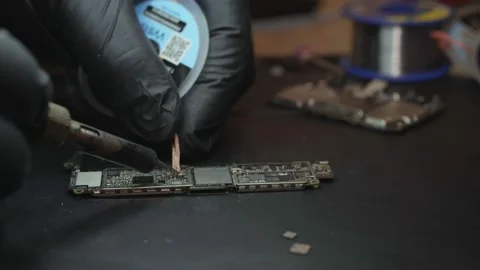 Master soldering a board for a smartphone Stock Footage 172057527