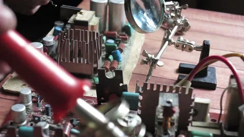 Master soldering radio components on the desktop Stock Footage 107038992
