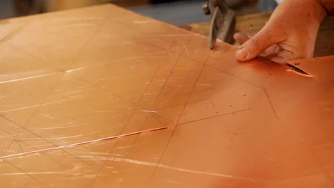 The master with special scissors for metal cuts the shape of the product Stock Footage 124424157