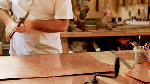 The master with special scissors for metal cuts the shape of the product Stock Footage 124443583