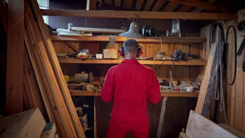 The master stands in his workshop under a swinging lamp. Stock Footage 318586812