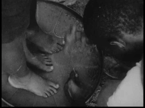 A master steel drum maker in Trinidad taps out sections of a steel pan with a Video stock 75304533