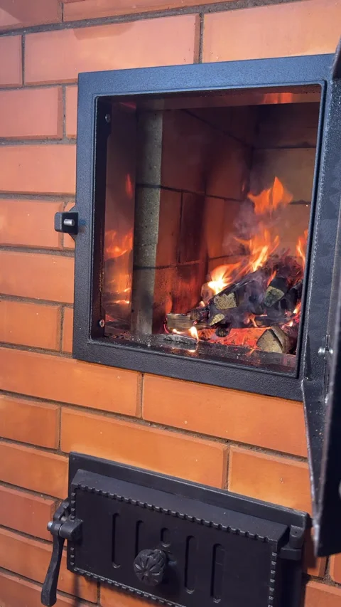 The master stove maker lights a test fire in the built stove. Close-up. Ver.. 動画素材 325623901
