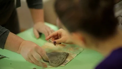 Master with students makes souvenirs from clay. Work process in an art workshop Stock Footage 81602475