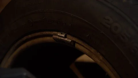 The master stuffs the load on the wheel, the process of balancing the wheel Stock Footage 126508900