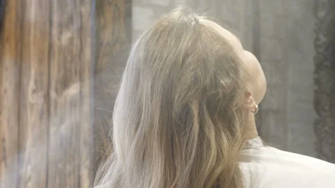 Master stylist makes the bride wedding hairstyle using spray lacquer fixing Stock Footage 107194501