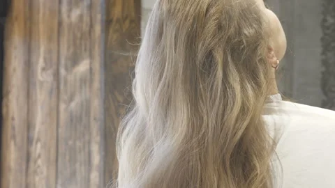 Master stylist makes the bride wedding hairstyle using spray lacquer fixing Stock Footage 107194657