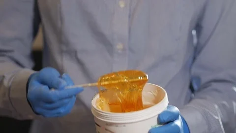 The master of sugar depilation mixes the paste Stock Footage 74396263