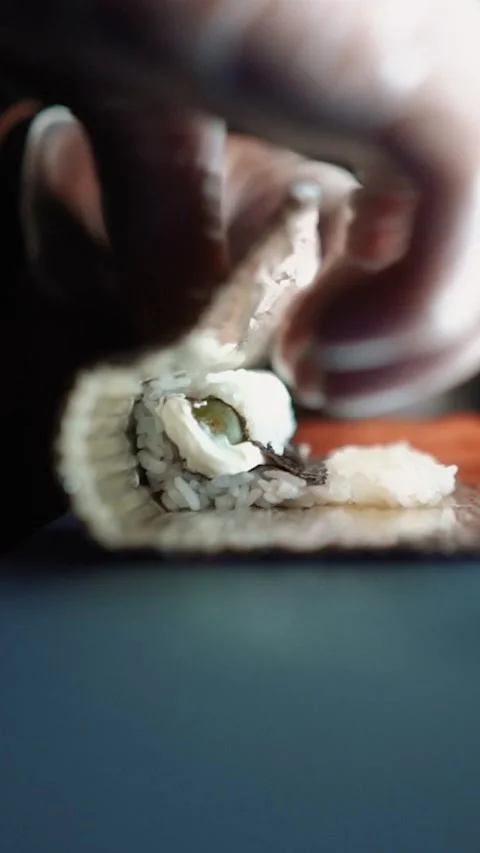 Master sushi maker makes sushi rolls from nori rice and red fish, the process of Stock Footage 256252492