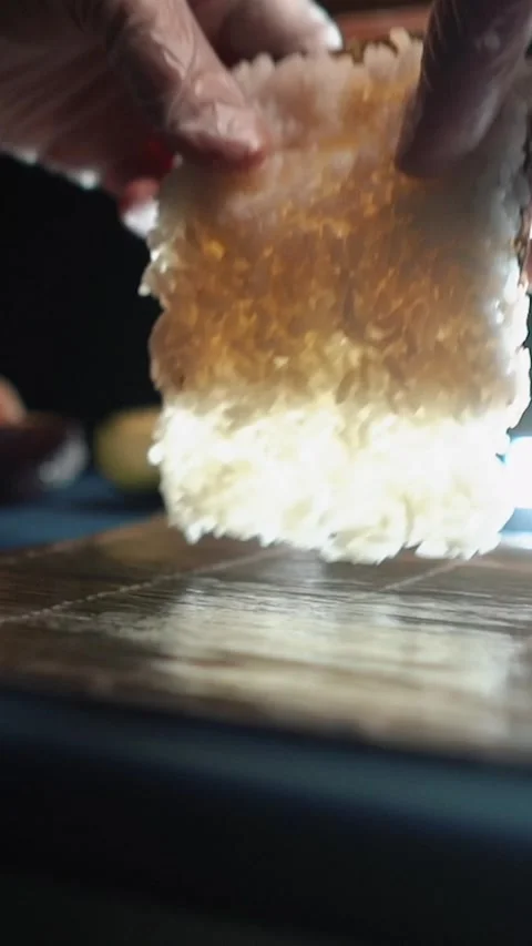 Master sushi maker makes sushi rolls from nori rice and red fish, the process of Stock Footage 256252774