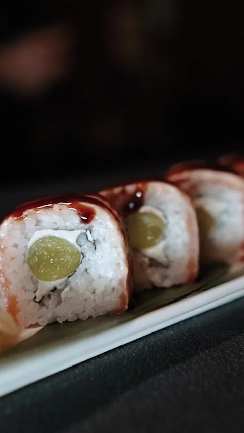 Master sushi maker makes sushi rolls from nori rice and red fish, the process of Stock Footage 256302617