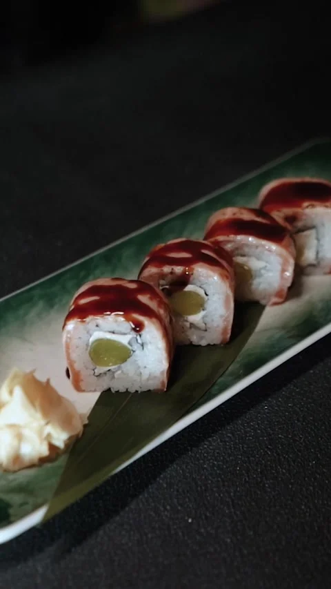 Master sushi maker makes sushi rolls from nori rice and red fish, the process of Video stock 256302749