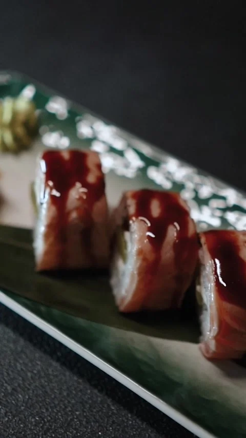 Master sushi maker makes sushi rolls from nori rice and red fish, the process of Stock Footage 256302904