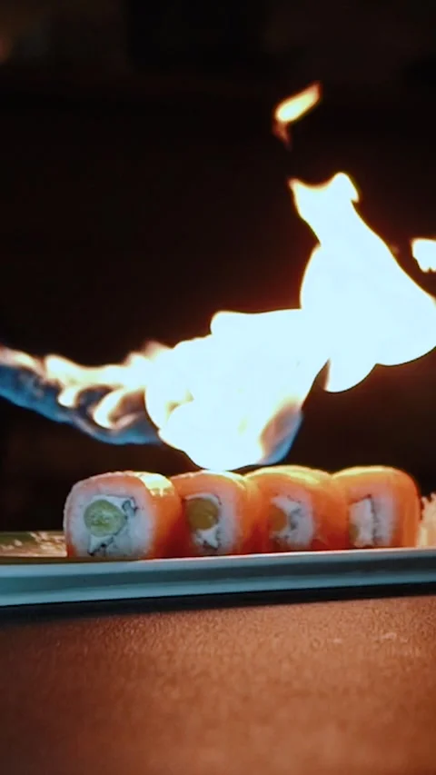 Master sushi maker makes sushi rolls from nori rice and red fish, the process of Stock Footage 256303045