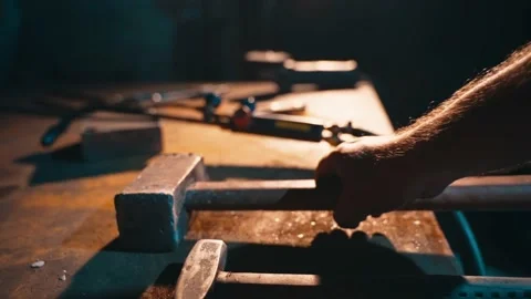 The master takes a hammer from the table for forging metal in the forge. Stock Footage 225875385