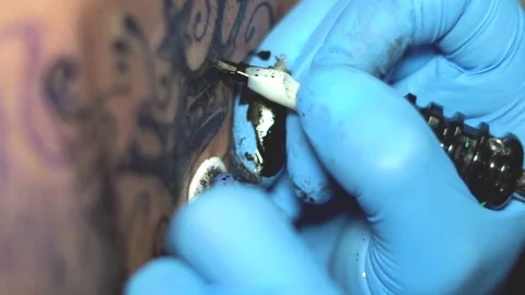 Master tattoo is drawing on the back Stock Footage 83674188