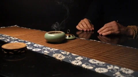 Master of tea ceremonies puts a container with incense Stock Footage 107822866