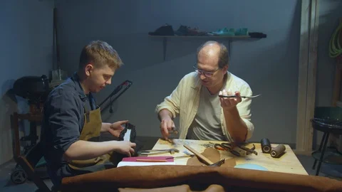 Master teaches apprentice how to work with skin 스톡 동영상 127835782