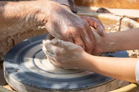 Master teaches apprentice pottery. Ceramic vase molding Stock Photos