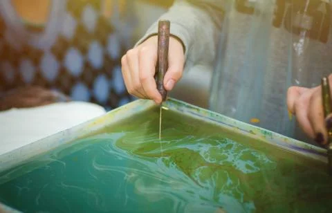 The master teaches the technique of ebru. Hands close up Stock Photos