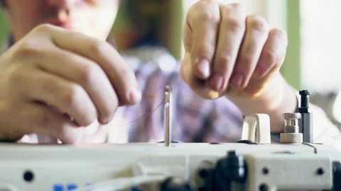 The master threads into the sewing machine Stock Footage 104133357