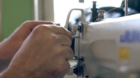 The master threads into the sewing machine Stock Footage 111452589