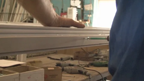 Master tightening the set screws into the frame Stock Footage 75155669
