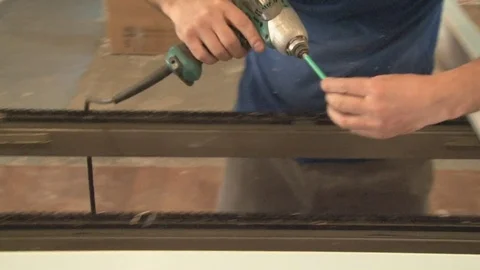 Master tightening the set screws into the frame Stock Footage 75155833