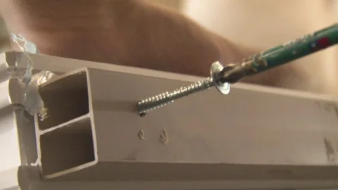 Master tightening the set screws into the frame Stock Footage 75156107