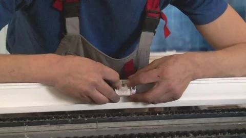 Master tightening the set screws into the frame Stock Footage 75156132