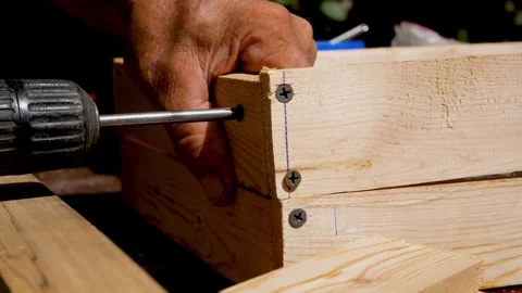 The master tightens the screw with a screwdriver during the manufacture of a Stock Footage 318874147