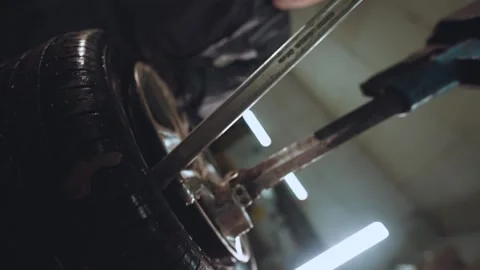 The master of tire fitting in the workflow, tire fitting, wheel bordering Stock Footage 253811070