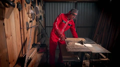 The master turns on the machine to saw the board. Stock Footage 318586287