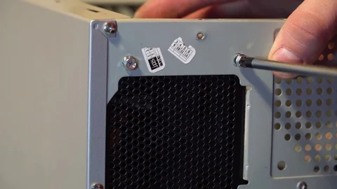 The master twists the bolt into the computer case Stock Footage 83168017