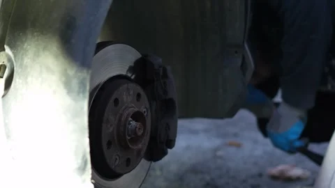 The master unscrews the bolt with a screwdriver and removes the protective plast Stock Footage 320127921